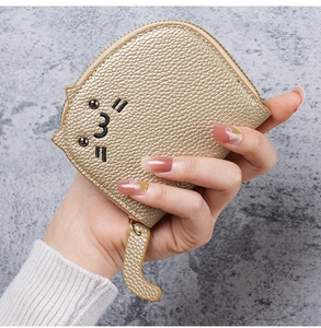 Close-up of golden cat-shaped coin purse featuring litchi grain PU leather and cat tail zipper