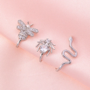 Silver non-piercing U-shaped nose clips featuring bee, spider and snake with zircons