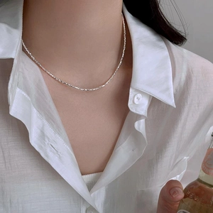 Elegant 925 silver plated irregular nugget necklace on a female neck with white shirt