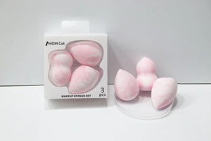Detailed view of three marble pattern makeup sponges with elegant white packaging box
