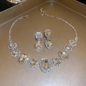 Oval cut crystal choker necklace and earring set with shimmering silver plating