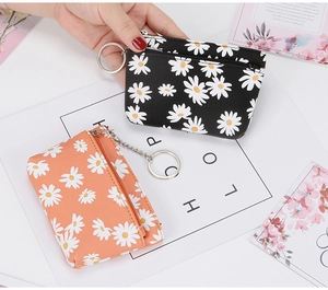Daisy print mini coin purse with metal zipper and keychain in black and coral orange