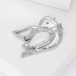 Macro view of the secure silver safety pin backing on this elegant bird lapel pin