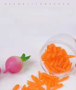 Macro shot of miniature 1.8cm resin carrots and pink radish for DIY craft scenery