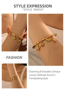 Detail of gold-plated bamboo texture bangle featuring starfish and tropical fish charms