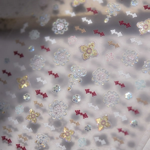 Detail of vintage palace style nail stickers with shell luster and 3D floral patterns