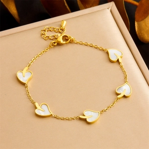 Elegant gold titanium steel heart pendant bracelet featuring white shell inlay on a jewelry box