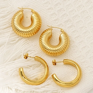 Set of two vintage hollow C-shaped gold hoop earrings in smooth and textured metal style