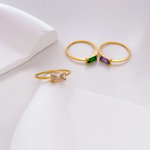 Tre anelli minimalisti dorati con cristalli rettangolari verde, viola e trasparente