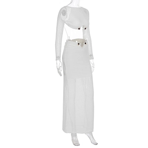 Detail of white lace two-piece set featuring long-sleeved crop top and ankle-length skirt