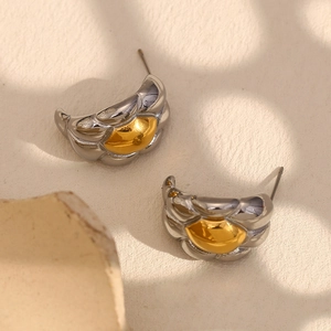 Detail showing two-tone 18K gold plated stainless steel wide horn earrings in macro view