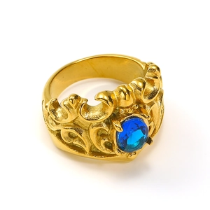 Detailed close-up of 18k gold plated crown ring with faceted blue gemstone inlay