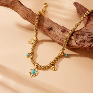 Vintage stainless steel necklace with blue turquoise clover and life tree pendant on wood