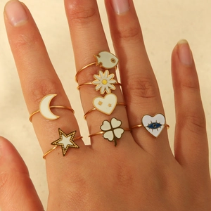 Detail view of 7-piece gold-plated open ring set with clover and evil eye enamel charms