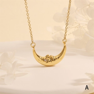 Macro shot of 18k gold crescent moon face pendant with zircon inlay and fine texture