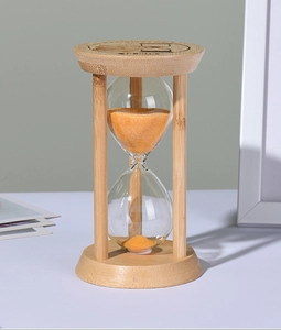 Close-up of bamboo sand timer with orange sand and TIME engraved on the wooden top