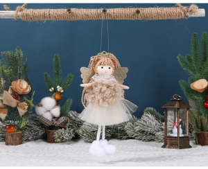 Close-up of handmade angel Christmas ornament with gold glitter wings and white tulle skirt