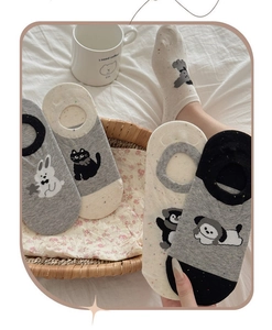 Close-up of assorted thin summer invisible socks with cute animal patterns in a basket