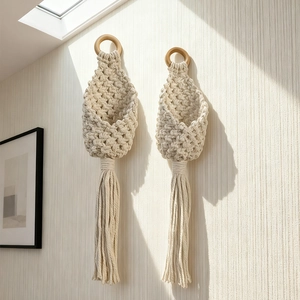 Set of 2 bohemian woven cotton rope wall baskets with wooden rings and long tassels