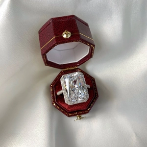 Macro shot of 1-5 carat radiant cut cubic zirconia ring in a luxury red velvet box