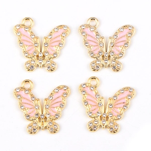 Detailed close-up of four pink enamel butterfly pendants with crystals and gold plating