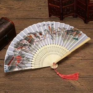 Detail of Chinese folding fan with Jiangnan water town landscape and red tassel