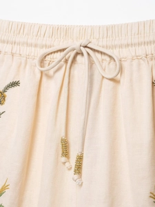 Close-up of elastic waistband with cotton drawstring and floral embroidery details