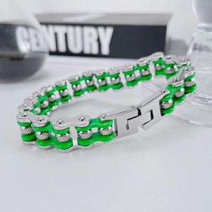 Detail of silver and neon green stainless steel biker chain bracelet with folding clasp