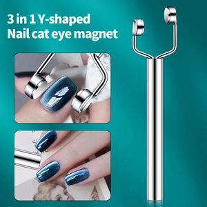 Y-shaped nail art magnet tool creating light effects on blue cat eye nail polish