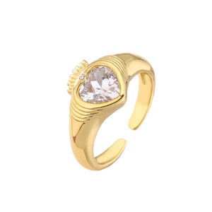 Macro view of gold heart ring with crown crown setting and cubic zirconia gemstone