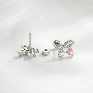 Elegant bow stud earrings with pink and blue heart gems and screw back closure