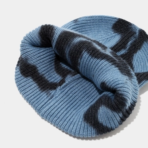 Detailed top view of ribbed knit beanie featuring blue and black tie-dye pattern