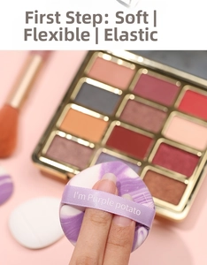 Macro shot of finger cushion puff with purple marble texture and soft ribbon handle
