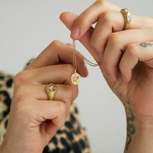 Handcrafted gold-plated LOVE heart pendant necklace and rings set worn on hand
