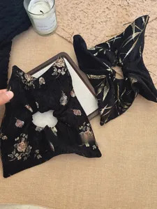 Macro view of vintage jacquard square scrunchies with floral and bamboo leaf patterns
