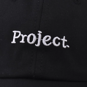 Black cotton baseball cap featuring 3D white embroidered Project text detail