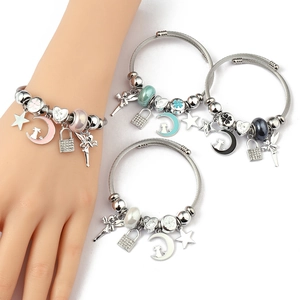 Detail view of woven steel cuff bracelets with colorful charms and heart pendants