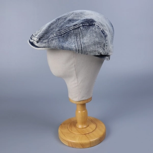 Vintage washed dark blue denim newsboy cap with soft brim and distressed texture