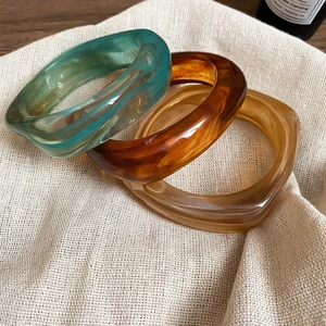 Close-up of translucent colorful acrylic resin bangles with irregular geometric design