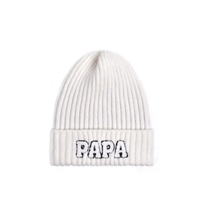 Detailed close-up of white ribbed knit beanie featuring black PAPA letter embroidery