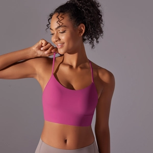 Detail of rose pink yoga sports bra featuring racerback design and seamless fabric
