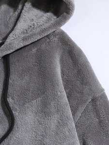 Close-up of gray coral fleece hoodie showing soft plush texture and black drawstrings