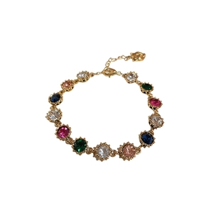 Elegant gold bracelet featuring colorful round-cut crystal gemstones with lobster clasp
