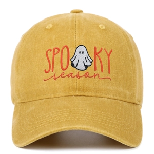 Detail shot of mustard yellow cotton baseball cap with Spooky Season ghost embroidery