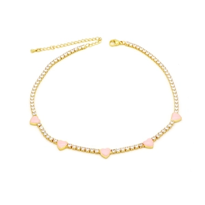 Detailed macro of gold-plated choker with pink heart charms and zircon crystals