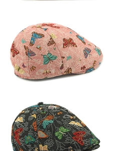 Detail view of ethnic jacquard beret with vibrant butterfly embroidery texture
