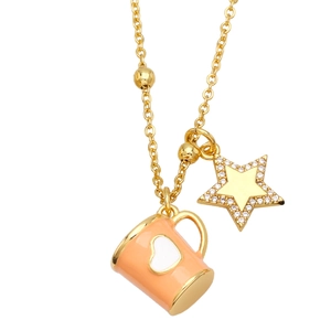 Close-up of gold chain necklace featuring pink enamel cup and sparkling star pendants