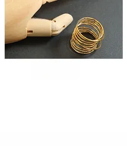 Detail of a multi-layer gold spiral cuff bracelet featuring unique handcrafted brass design