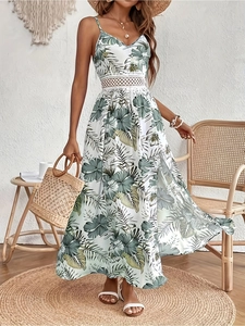 Elegant white floral maxi dress with green leaf print, V-neck and waist cut-out details