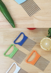 Close-up of stainless steel onion needles with colorful ergonomic handles on wooden board